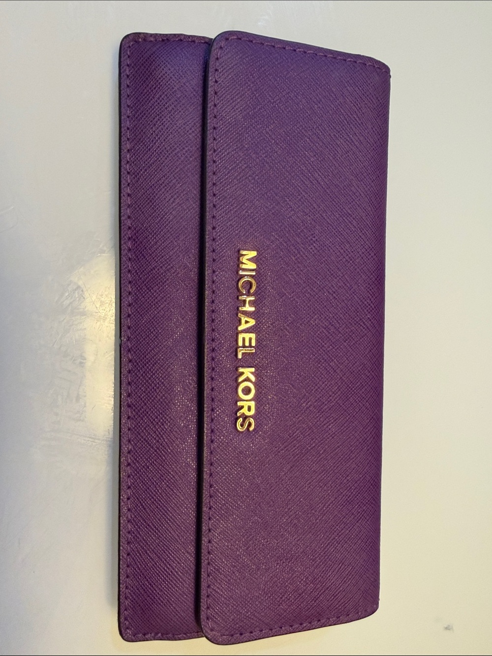 Michael Kors purple wallet-like accessory